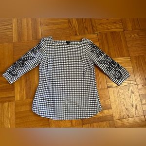 Talbots navy checkered blouse with open details on sleeves.